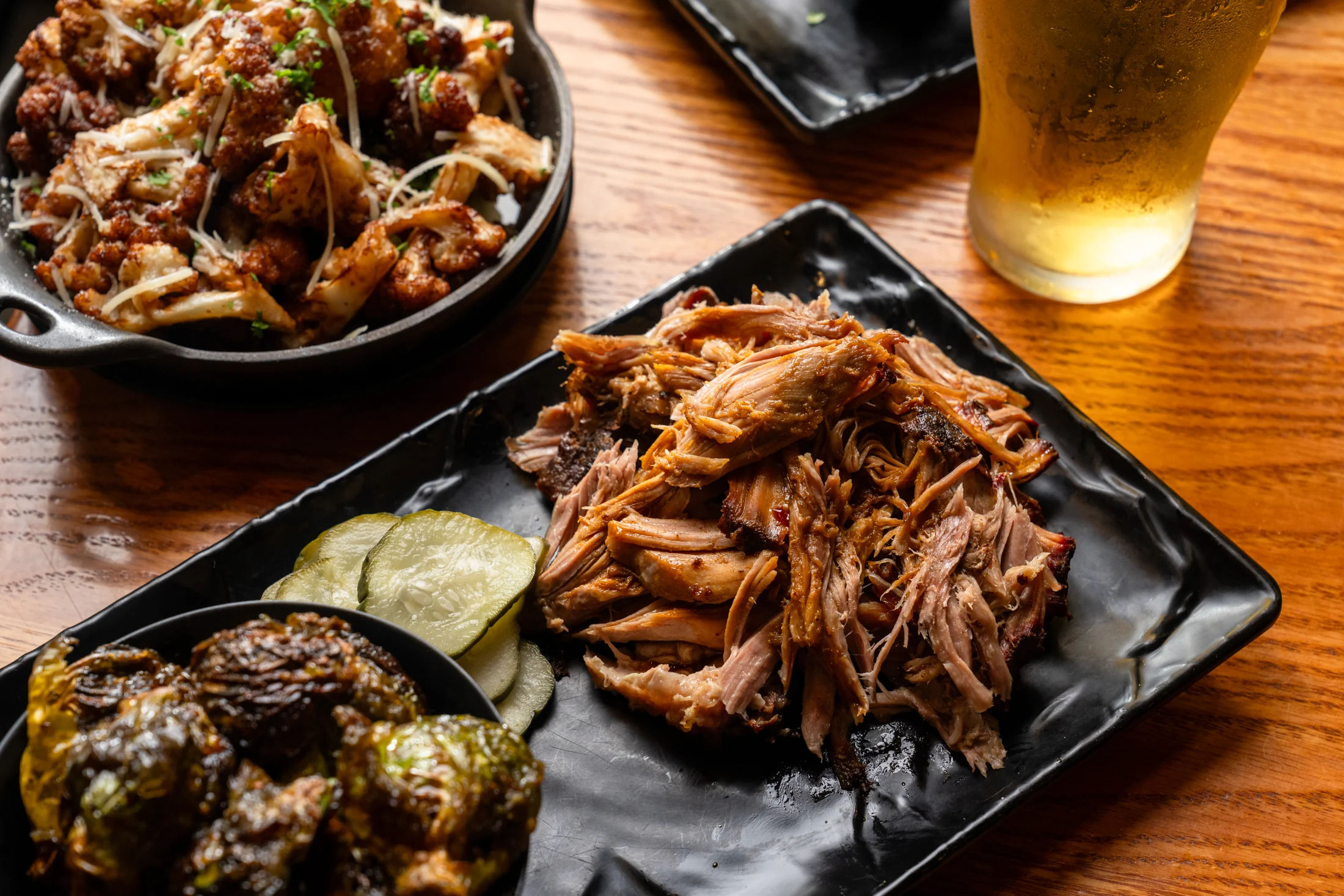 Pulled pork, roasted Brussels sprouts and accompaniments at Smokecraft